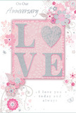 This anniversary card presents a tender celebration of enduring romance, reminiscent of a graceful bouquet waiting to be delivered to an Addington doorstep. At the centre, the word LOVE stands out in softly raised glitter, each letter smooth yet sparkling, with the O transformed into a shimmering silver heart that becomes the natural focal point. This heart glows against a blush-pink panel, surrounded by a wider field of pale pastel pinks and muted silvery greys that create a feeling of treasured intimacy and calm. All around the central word, delicate blooms in blush, mauve, and gentle ivory unfurl across the card's surface. Their forms have the softness of watercolour-petals fading at the edges, lines flowing rather than rigid-evoking the relaxed charm of an English spring garden like those tucked away near Addington's quieter streets. Tiny flourishes-curled tendrils, scattered petals, and subtly drawn butterflies-add a sense of movement, as if a breeze were drifting through the design. The background remains light and airy, allowing the floral motifs and central heart to breathe. Above and below, flowing script spells out On Our Anniversary and I love you today and always, the lettering fine and graceful, much like a handwritten note tucked into a bouquet arranged by Florist Addington. The overall impression is soft yet deeply heartfelt-a card that feels like a keepsake, ideal for marking a shared journey with warmth, tenderness, and the quiet joy of love that has grown over time.